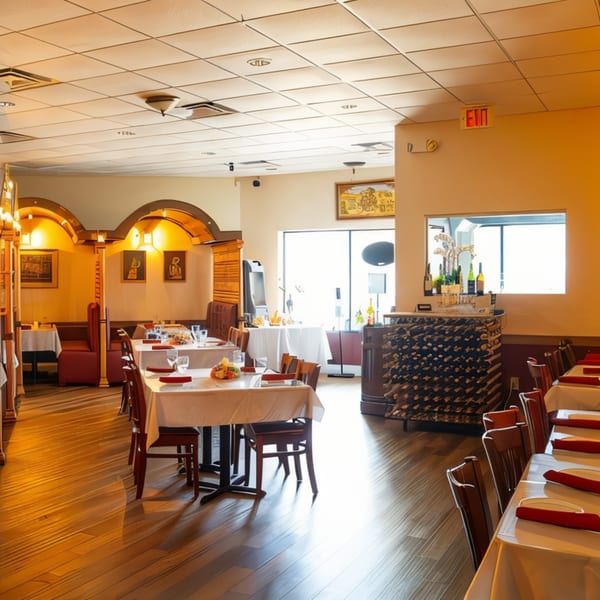 The Palace Indian Restaurant's dining room features set tables, arched booths, and a wine rack.
